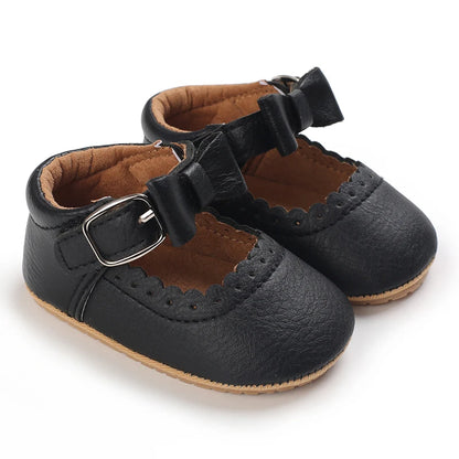 black baby girl shoes with faux buckle and bow detail