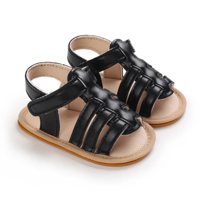 Black Marlow baby fisherman sandals featuring classic woven-style straps, flexible soles and adjustable Velcro fastening | Pipp & Lola