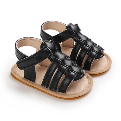 Black Marlow baby fisherman sandals featuring classic woven-style straps, flexible soles and adjustable Velcro fastening | Pipp & Lola