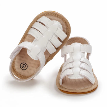 Close-up of white Marlow baby fisherman sandals featuring woven-style straps, adjustable Velcro fastening and flexible soles | Pipp & Lola