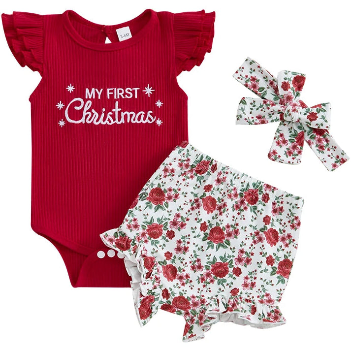 Baby outfit set with red 'My First Christmas' onesie, floral romper, and headband on a white background